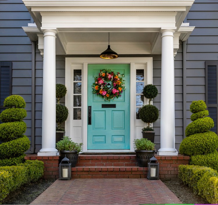 Choosing a large wreath for the front door can be a seasonal change. The most important part is to go big.