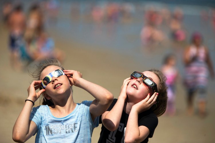People all over Maine donned protective glasses to glance up a  partial solar eclipse in 2017. 