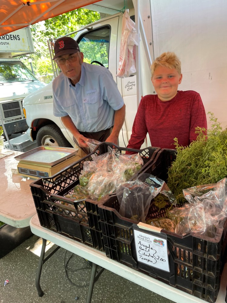 Jodie Jordan, left, selling produce with great nephew Bennett Rideout 